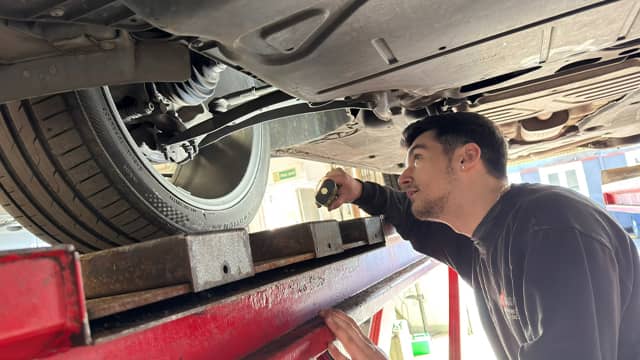 Mechanic Inspecting a Driveshaft at TC Garage